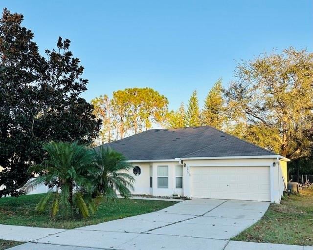 ranch-style house with cooling unit and a garage