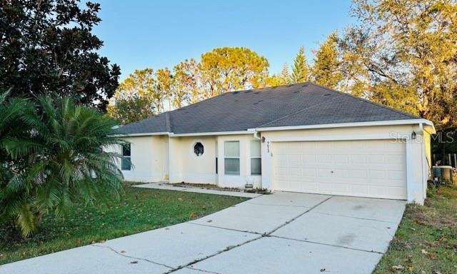 ranch-style home featuring a garage