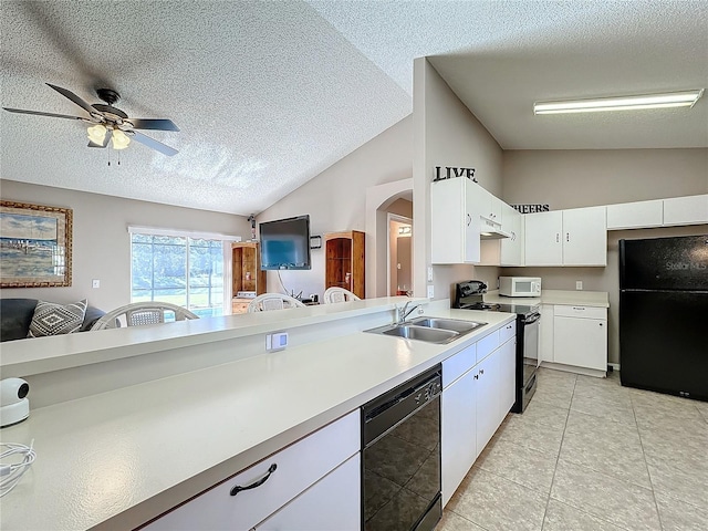 kitchen featuring a textured ceiling, sink, black appliances, and lofted ceiling