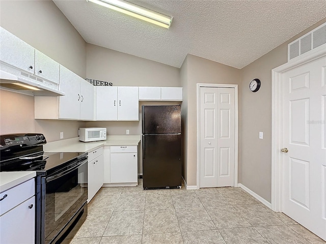 kitchen featuring a textured ceiling, vaulted ceiling, black appliances, light tile patterned floors, and white cabinets