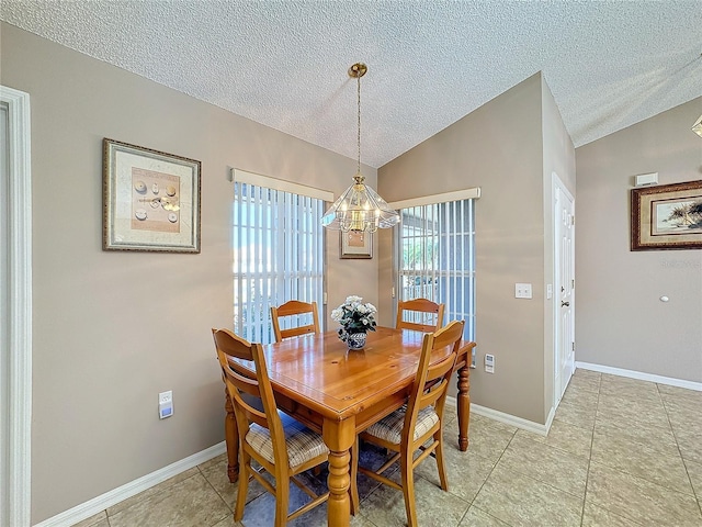 tiled dining area featuring a textured ceiling, a chandelier, and vaulted ceiling