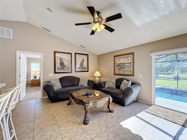 tiled living room with ceiling fan, a textured ceiling, and vaulted ceiling