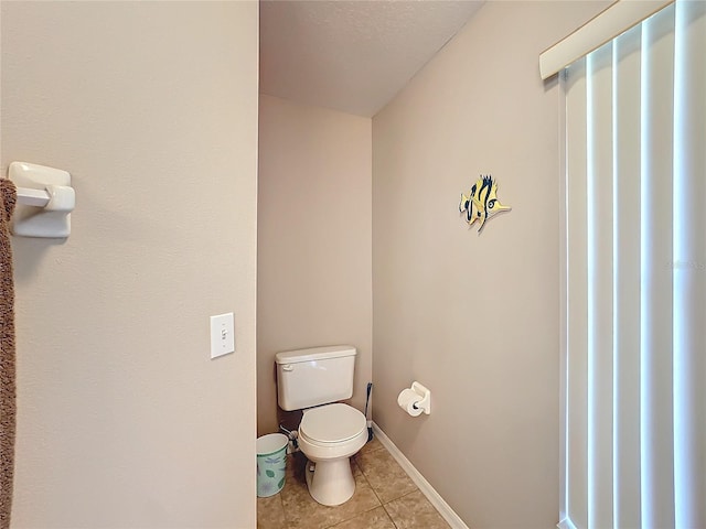 bathroom featuring tile patterned floors and toilet