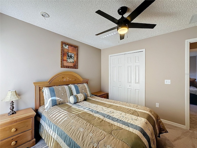 bedroom with carpet, a textured ceiling, a closet, and ceiling fan