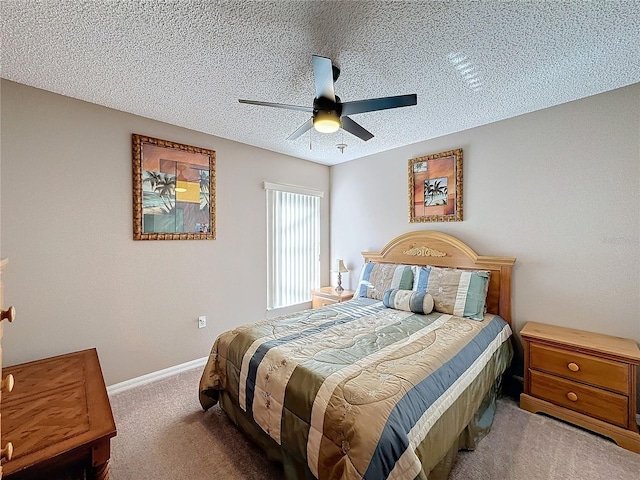 carpeted bedroom featuring ceiling fan and a textured ceiling