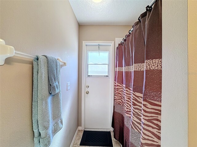 entryway with a textured ceiling