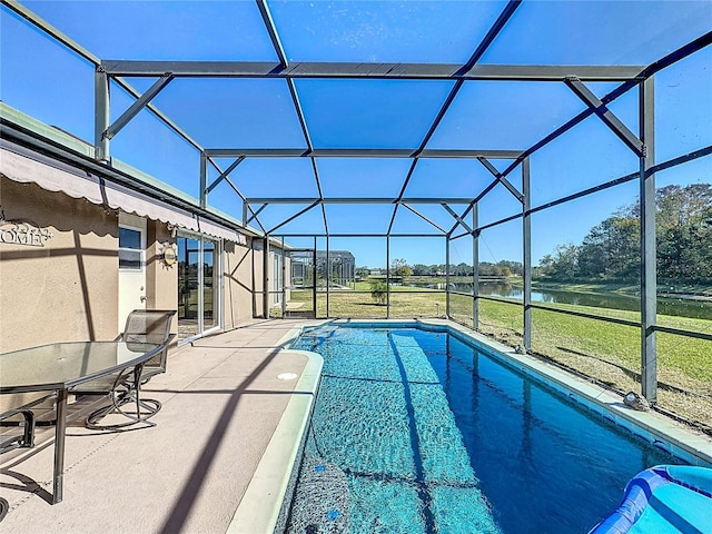 view of pool featuring a patio, a water view, and a lanai