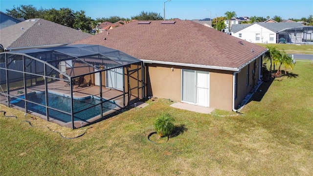 back of property with a patio, a lanai, and a lawn