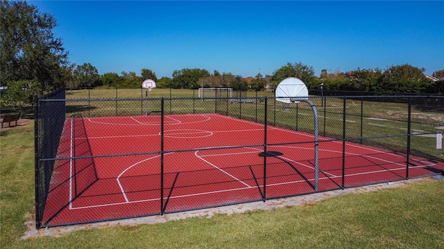 view of basketball court featuring a yard