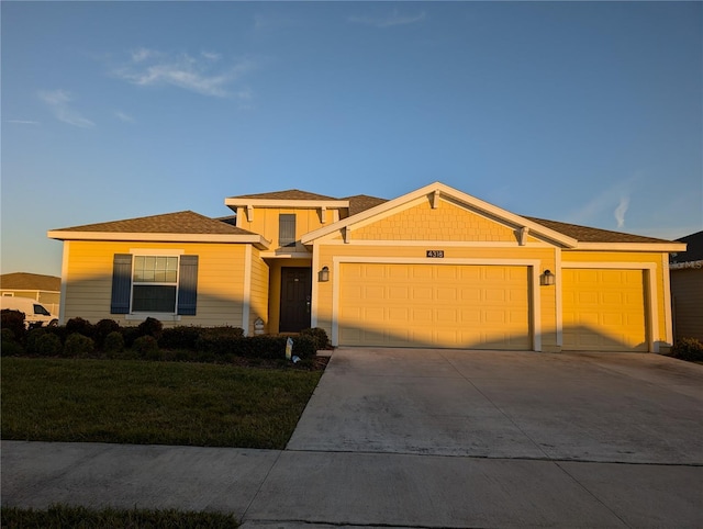 view of front of home featuring a garage and a front lawn