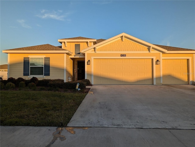 view of front of house with a garage and a front yard