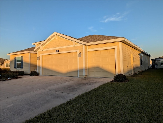 single story home featuring a garage and a front lawn