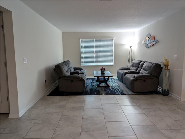 living room featuring light tile patterned floors and a textured ceiling