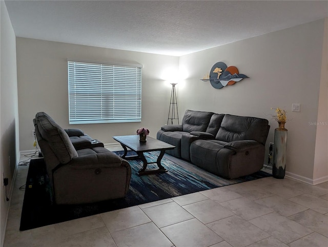 living room featuring light tile patterned floors and a textured ceiling