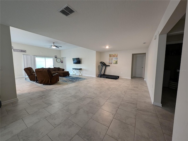 unfurnished living room featuring a textured ceiling and ceiling fan