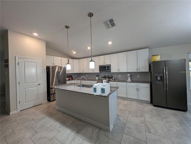 kitchen featuring white cabinetry, sink, hanging light fixtures, vaulted ceiling, and appliances with stainless steel finishes