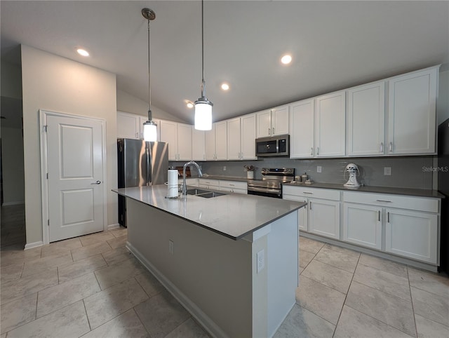 kitchen featuring stainless steel appliances, sink, a center island with sink, white cabinetry, and lofted ceiling