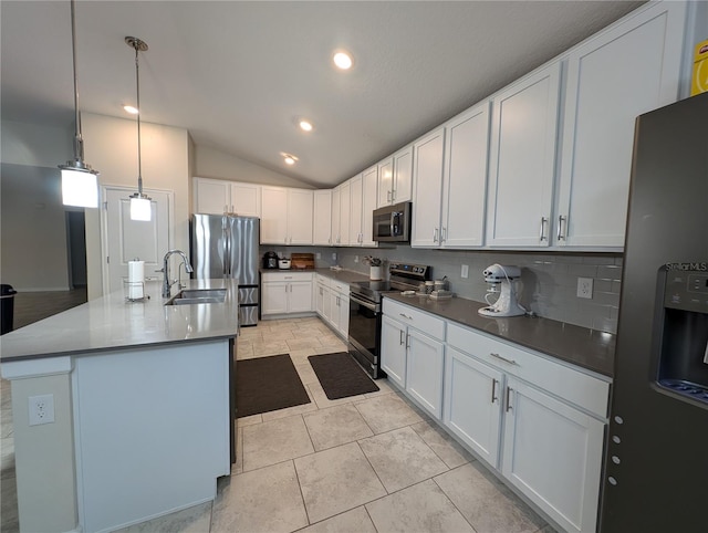 kitchen with stainless steel appliances, pendant lighting, lofted ceiling, a kitchen island with sink, and white cabinets