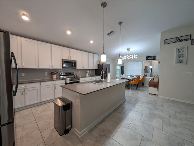 kitchen featuring white cabinets, pendant lighting, and appliances with stainless steel finishes