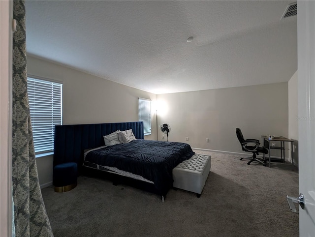 carpeted bedroom with a textured ceiling