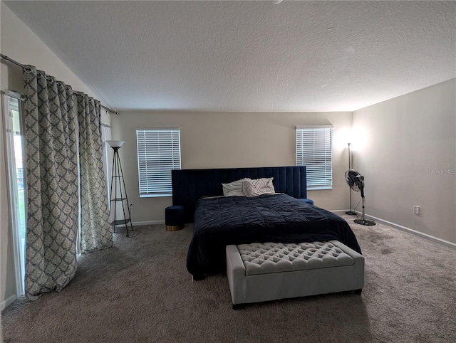 carpeted bedroom featuring lofted ceiling and a textured ceiling