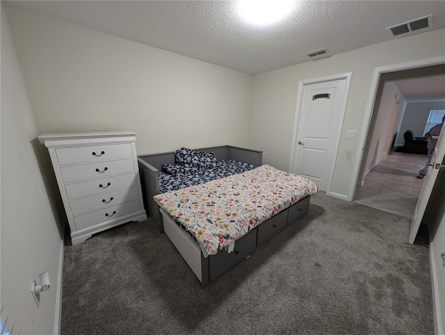 carpeted bedroom featuring a textured ceiling