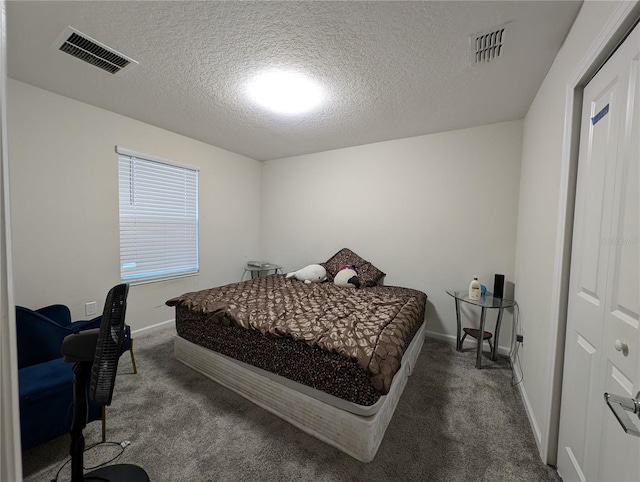 carpeted bedroom with a textured ceiling and a closet