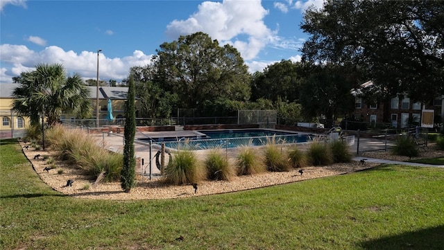 view of pool featuring a yard