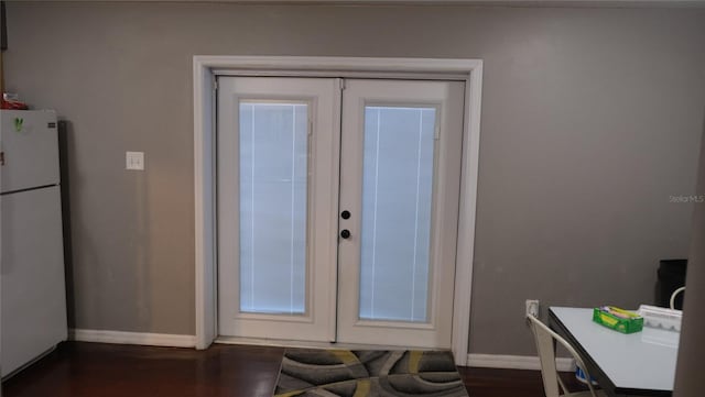 doorway to outside featuring french doors and dark wood-type flooring