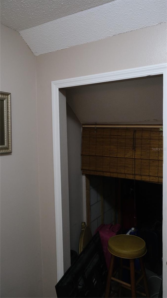 details with a textured ceiling and a tiled fireplace