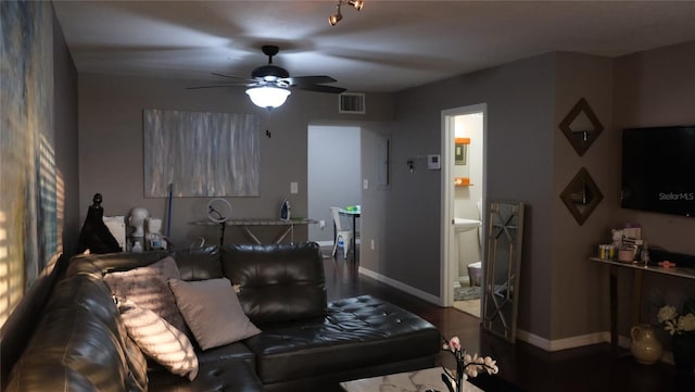 living room with ceiling fan and dark wood-type flooring