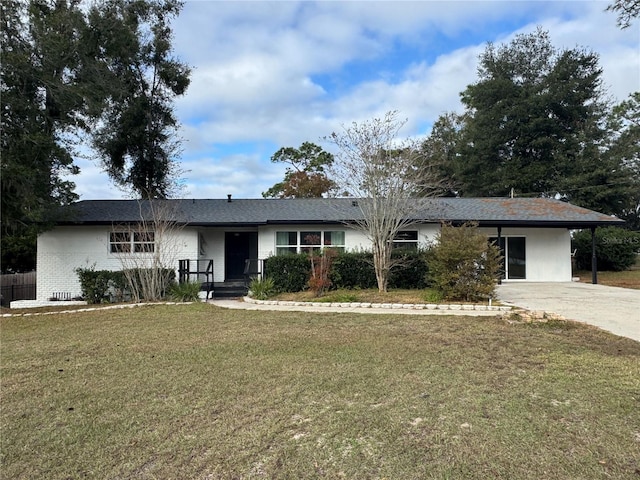 ranch-style house featuring a carport and a front lawn