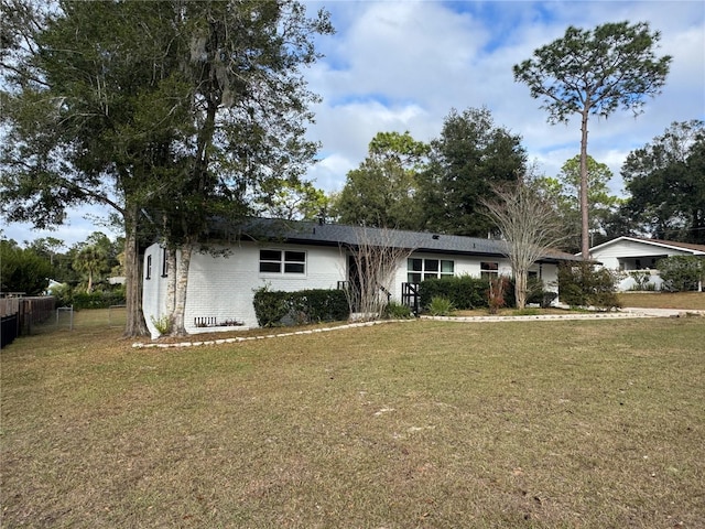 ranch-style home featuring a front yard