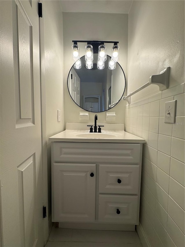 bathroom with tile patterned floors, vanity, and tile walls