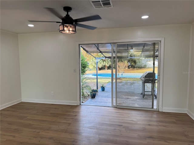 interior space featuring hardwood / wood-style floors, ceiling fan, and ornamental molding