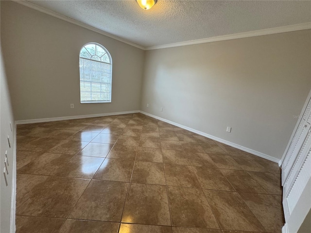 spare room featuring a textured ceiling, tile patterned floors, and crown molding