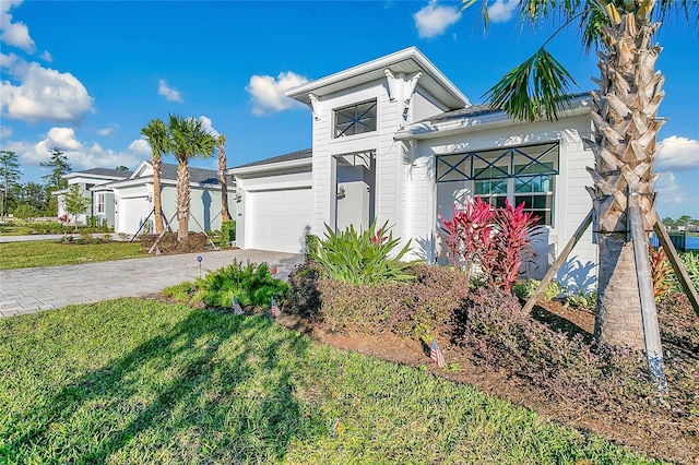 view of front of house with a front lawn and a garage