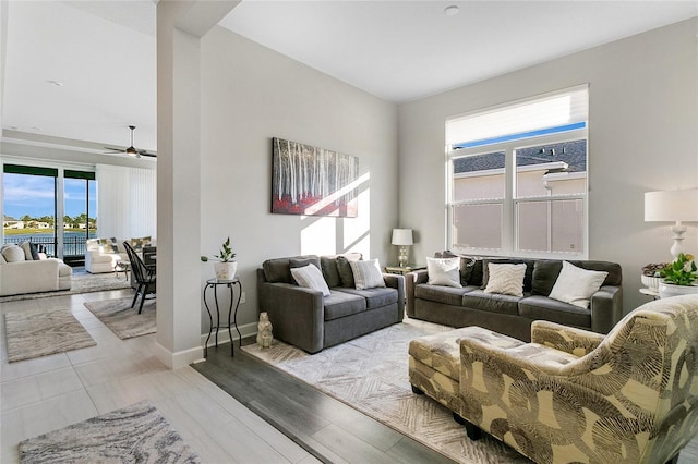 living room with ceiling fan and light hardwood / wood-style floors