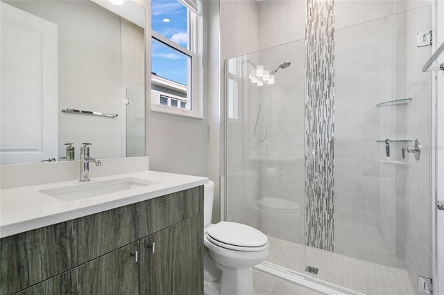 bathroom featuring vanity, toilet, and walk in shower