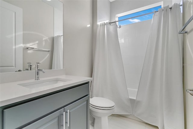 full bathroom featuring tile patterned floors, vanity, shower / tub combo, and toilet