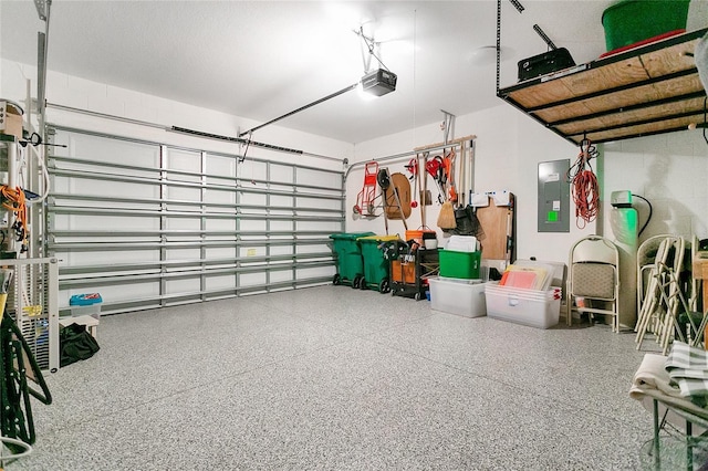 garage with electric panel and a garage door opener