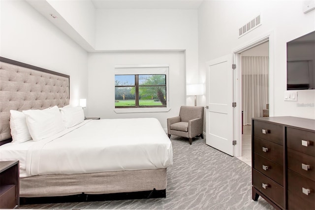 bedroom featuring a towering ceiling