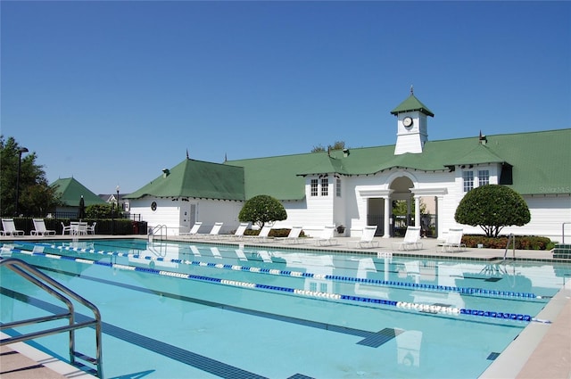 community pool featuring a patio area and fence