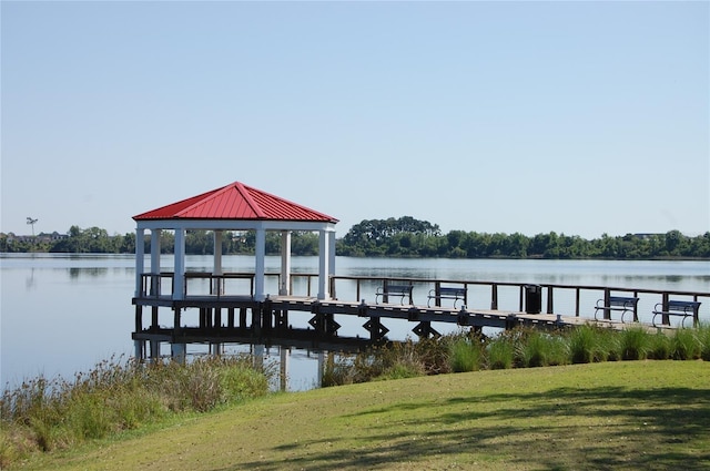 dock area featuring a gazebo, a lawn, and a water view