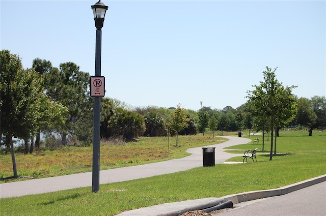 view of property's community with a lawn