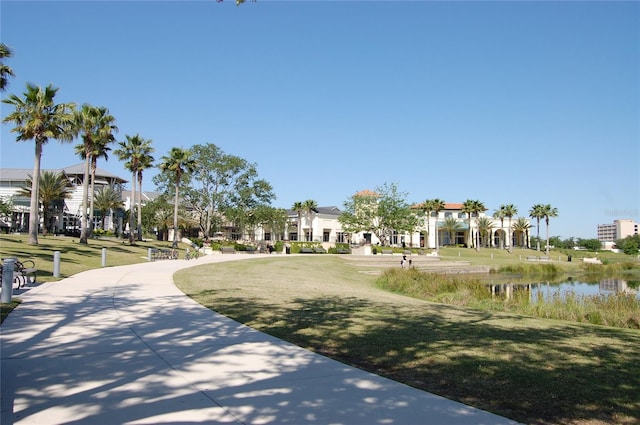 view of property's community with a residential view and a lawn