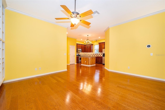unfurnished living room with crown molding, visible vents, baseboards, and light wood-style floors