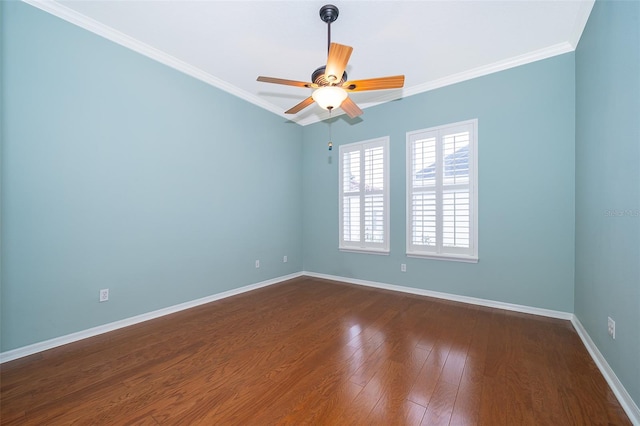 spare room featuring a ceiling fan, crown molding, baseboards, and dark wood finished floors