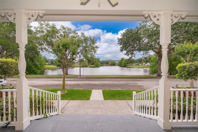 view of patio with a porch and a water view
