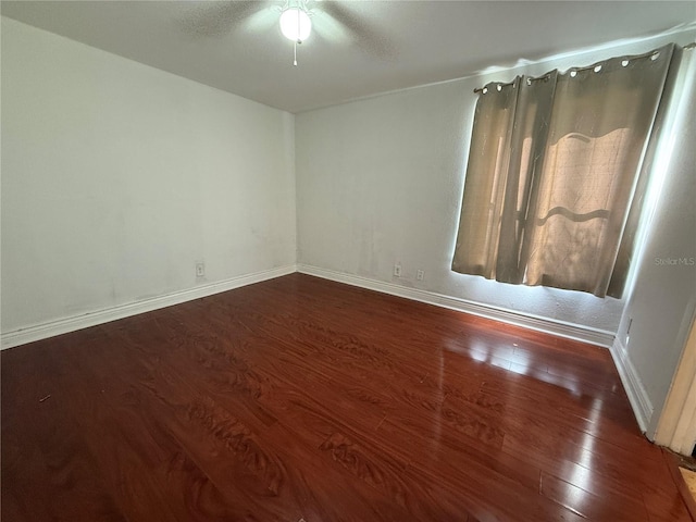 unfurnished room with dark hardwood / wood-style flooring